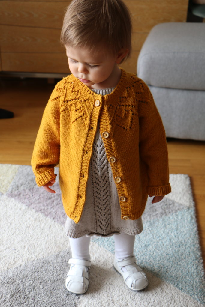 Lucie in home made knitted clothes
